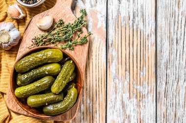 Tahta tabakta marine edilmiş salatalık turşusu. Hardallı ve sarımsaklı turşu. Beyaz arka plan. Üst Manzara. Boşluğu kopyala.