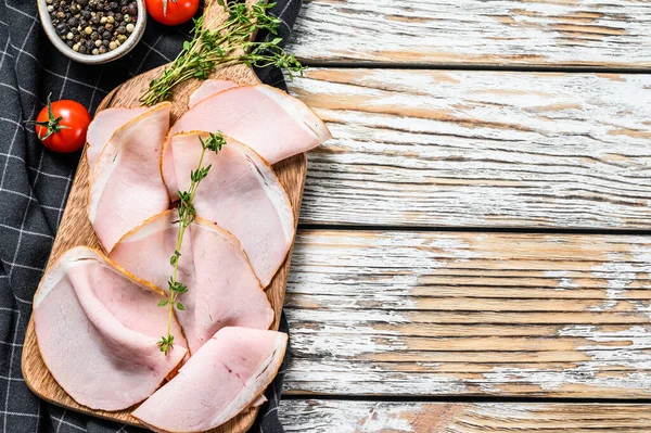 Smoked meats, sliced smoked pork loin. White background. Top view. Copy space.