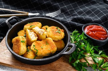 Ketçap ve bitkilerle tavada kızarmış tavuk nugget. Beyaz arka plan. Üst görünüm.