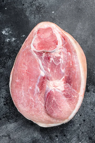 Raw pork ham cut. Leg meat. Black background. Top view.