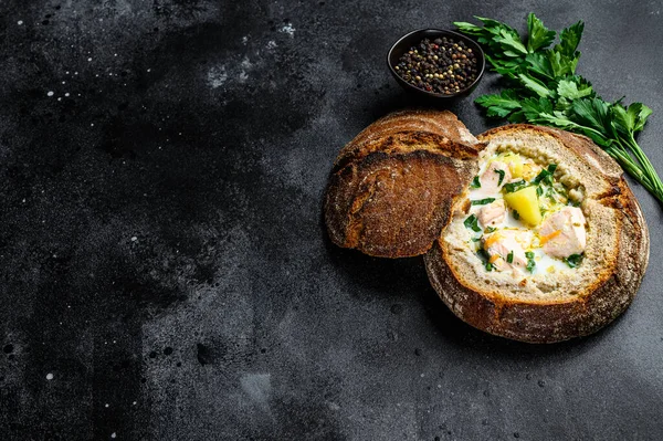 Salmon soup served in bread. Creamy hearty fish soup. healthy and diet food concept. Black background, top view, space for text. — Stock Image Salmon Soup Served Bread Creamy Hearty Fish Soup Healthy Diet Royalty Free Stock Photos