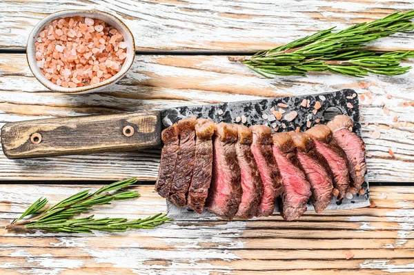 Grilovaný steak z rampy na sekáčku na maso. Bílé dřevěné pozadí. Horní pohled — Stock fotografie