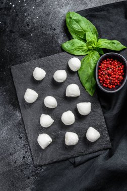 Mini mozarella peyniri topları, Caprese salatası için malzemeler. Siyah arka plan. Üst görünüm.
