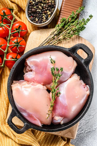 Boneless raw chicken thighs fillets. White background. Top view.