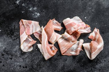 Çiğ domuz pastırması. Organik taze et. Siyah arka plan. Üst görünüm.