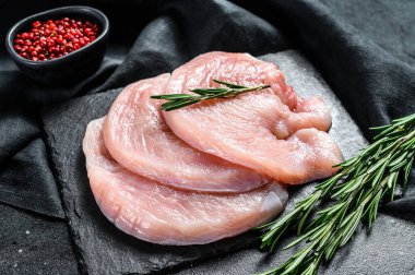 Çiğ hindi göğsü bifteği. organik kümes hayvanları. Siyah arka plan. Üst görünüm.