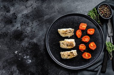 Baharatlı fırında balık fileto. Siyah arka plan. Üst Manzara. Boşluğu kopyala.