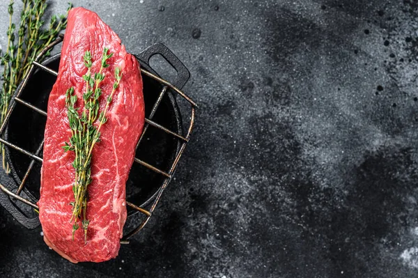 Raw Sirloin steak, beef meat. Dark Wooden background. Top view. Copy space.