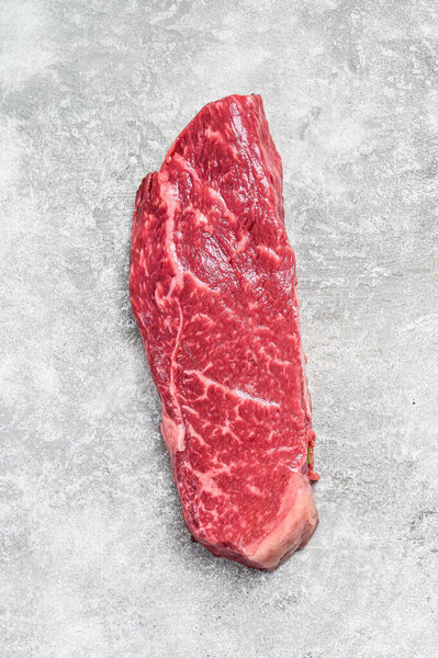 Raw Striploin steak, marbled beef. Gray background. Top view.