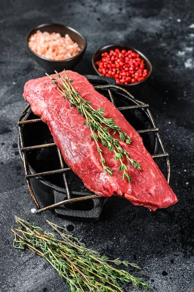 Raw Sirloin steak, beef meat. Dark Wooden background. Top view.