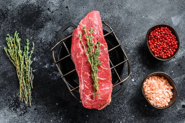 Raw Sirloin steak, beef meat. Dark Wooden background. Top view.