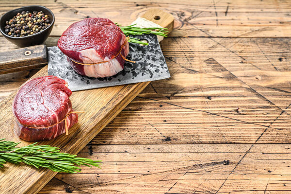 Raw beef meat steak Tenderloin fillet. Wooden background. Top view. Copy space.