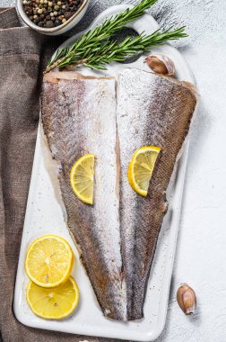 Biber ve limonlu taze çiğ balık fileto. Beyaz arka plan. Üst görünüm.