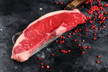 Satırda çiğ fileto biftek. Siyah Angus bifteği. Siyah arka plan. Üst görünüm.