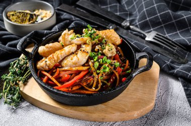 Erişteyi sebzeyle, tavukla karıştır. Yumurtalı erişte. Gri arka plan. Üst görünüm.