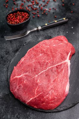 Fresh raw top sirloin steak, beautifully marbled and ready for grilling, perfect for meat lovers seeking quality. black background. top view.