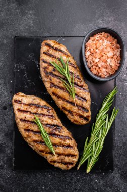 Grilled lula kebabs, perfect for an authentic Middle Eastern feast. black background. top view.