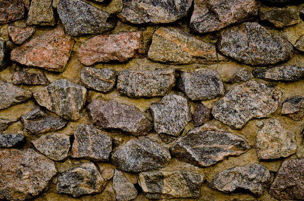 Masonry. Old masonry. The wall is built of stone. Architectural texture. Building stone.