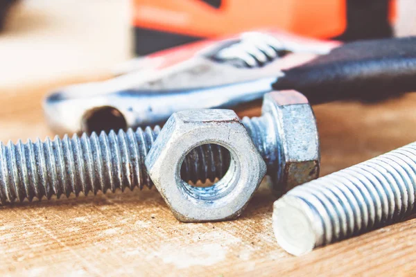 Çelik somun cıvata ve yıkıtakanlar ahşap tahtalar üzerinde yalan.