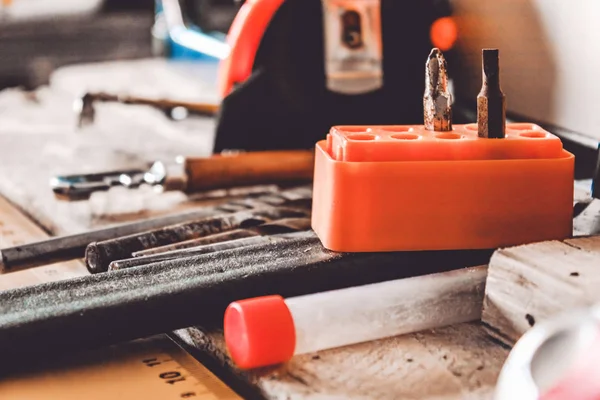 Tools for working with a wrench, a screwdriver and a drill are lying on the table. Various carpentry tools.