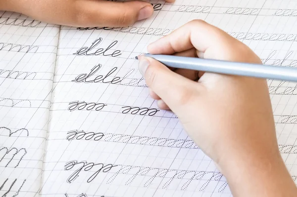 Schoolboy writing close-up. Pencil in the hand of children. — Stock Photo, Image