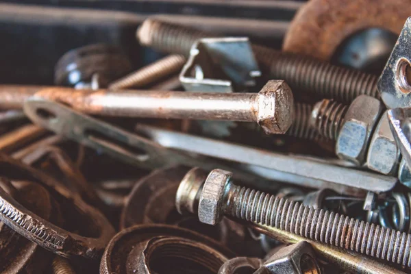 A pile of tools in a drawer that were used.