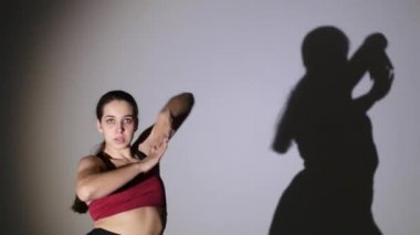 Dans eden genç güzel kız, gölge hareketlerini tekrarlıyor.