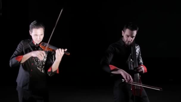 Duet Young Men Playing Electric Cello Electric Violin Black Background — Stock Video