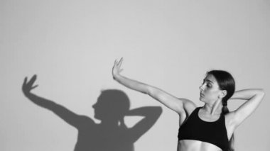 genç kız dans modern bale, çağdaş dans, izole, gölge onun hareketlerini tekrarlar, yavaş hareket