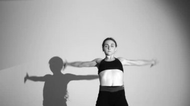 genç balerin dans çağdaş dans, izole, gölge onun hareketlerini tekrarlar, yavaş hareket