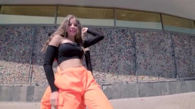 Çağdaş dans eden iki genç bayanın düeti, binanın karşısında dans salonu twerk 'i. Seks Dansı. Şehirde serbest dans yapan bir şehir. Gimbal atışı.