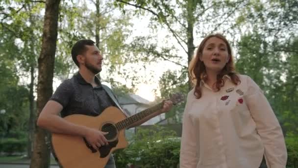 Handsome Guitarist Beard Playing Guitar Red Haired Girl Singing Outdoors — Stock Video