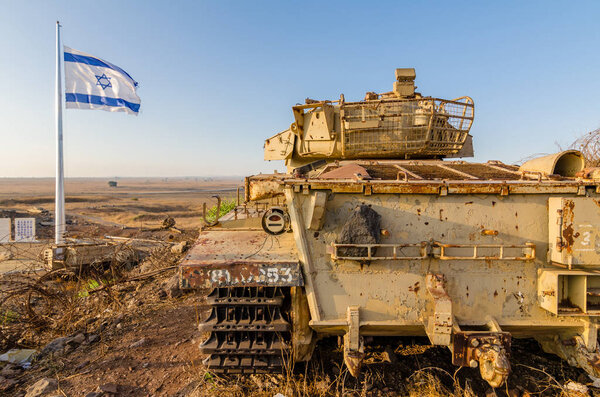 Israeli flag flying beside a decommissioned Israeli Centurion tank used during the Yom Kippur War at Tel Saki on the Golan Heights in Israel 