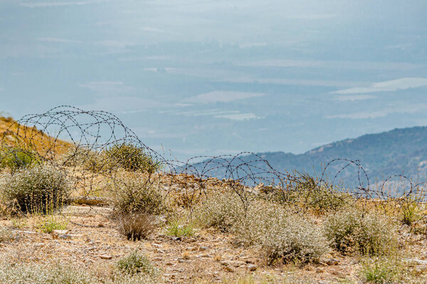 Barbed wire on the Mount Hermon hillside overlooking the fields of Lebanon