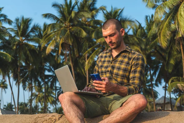 man works on the ocean. Freelancer talking on the phone. Business and leisure, work abroad