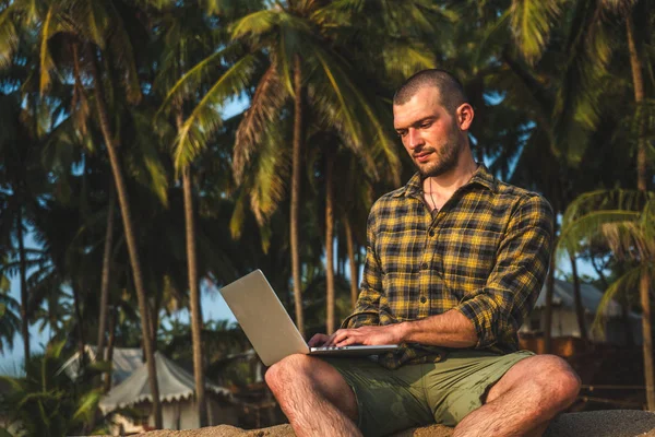 man works on the ocean. Freelancer talking on the phone. Business and leisure, work abroad