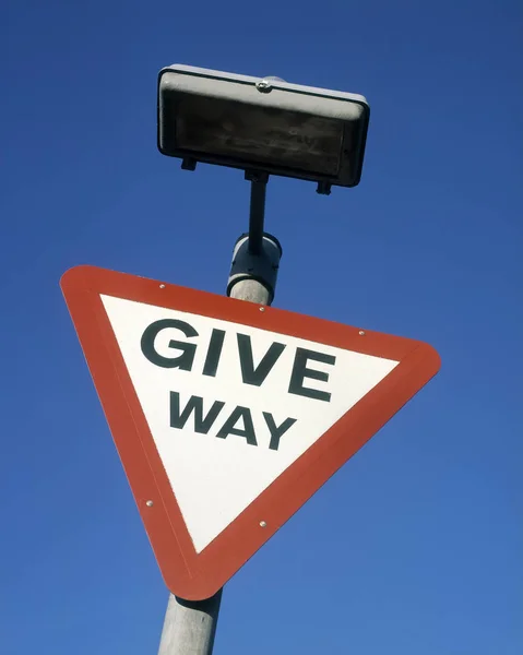 GIVE WAY ROAD TRAFFIC SIGN ISOLATED ON BLUE SKY BACKGROUND