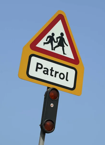 SCHOOL CROSSING PATROL SIGN ISOLATED ON BLUE SKY BACKGROUND