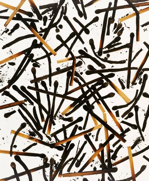 ABSTRACT ARRANGEMENT OF MATCHES ON WHITE BACKGROUND