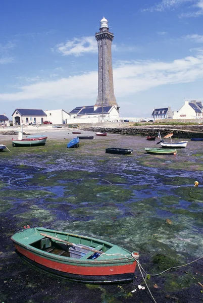 ROWING BOAT AND LIGHT HOUSE IN BRITTANY, FRANCE