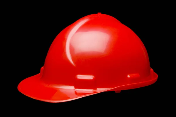 RED HARD HAT ON BLACK BACKGROUND