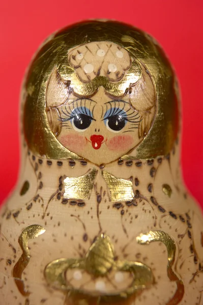 RUSSIAN DOLL ON RED BACKGROUND