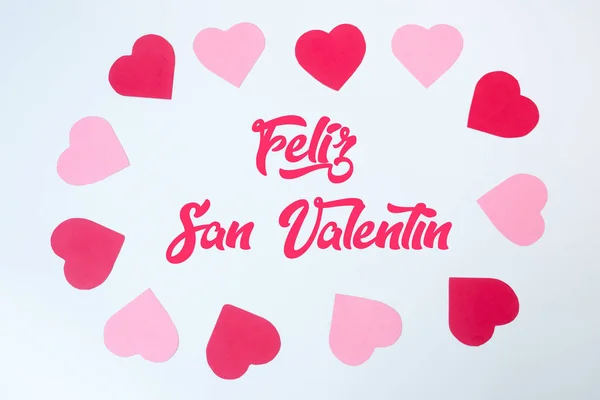 San Valentine day decoration card made with red and pink paper hearts. Gift card.