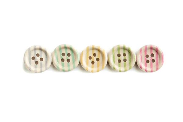 Wooden buttons with colorful stripes and colorful dots on a white background — 스톡 사진