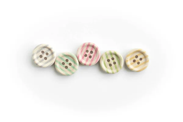 Wooden buttons with colorful stripes and colorful dots on a white background — 스톡 사진