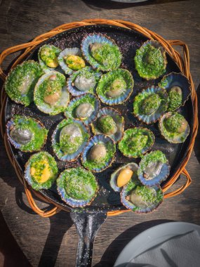grilled limpets with green mojo, typical avocado in Lanzarote clipart