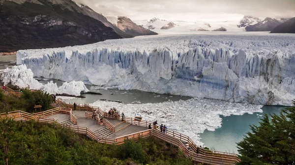 Wooden walkways in front of the ice wall of the Perito Moreno glacier in the Glacier National Park