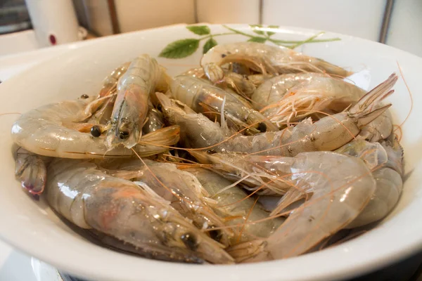 fresh wet raw prawns in the plate on the kitchen