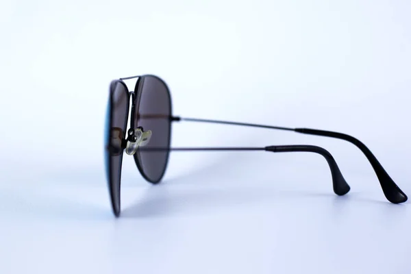 Blue mirrored sunglasses with anti-reflective coating and UV protection on a white background. — Stock Photo, Image