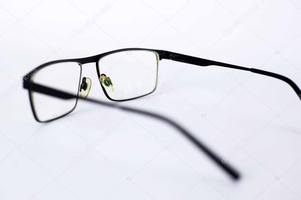glasses for the visually impaired, poorly sighted.glasses with aspherical astigmatic lenses  in black frame on a white background.